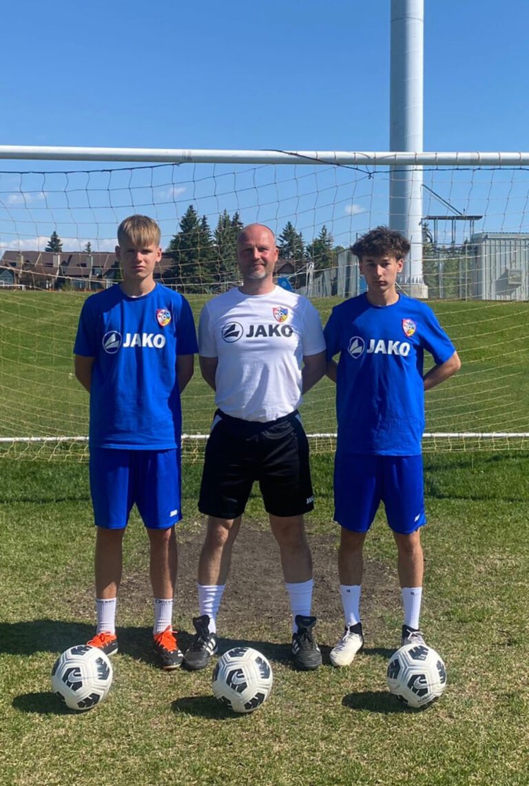 Players and their coach at the goal